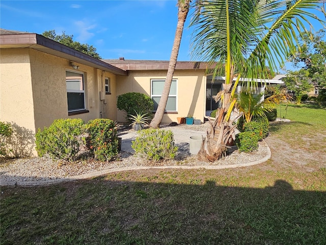 1510 Flamingo Ln, Sun City Center, FL 33573 - back of house featuring stucco siding and a lawn