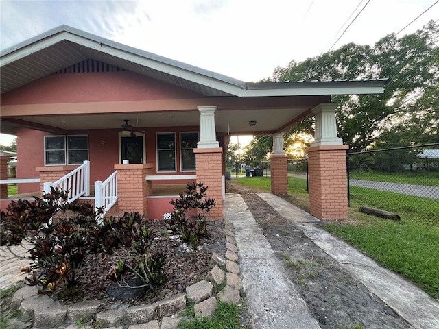 9907 Maggie St, Gibsonton, FL 33534 - view of front facade with concrete driveway, brick siding, a porch, and a ceiling fan