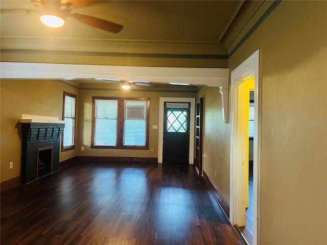 9907 Maggie St, Gibsonton, FL 33534 - foyer entrance featuring a ceiling fan, ornamental molding, dark wood finished floors, baseboards, and a brick fireplace