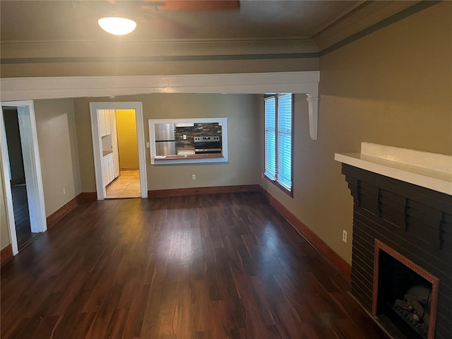 9907 Maggie St, Gibsonton, FL 33534 - unfurnished living room featuring a fireplace, wood finished floors, crown molding, and baseboards