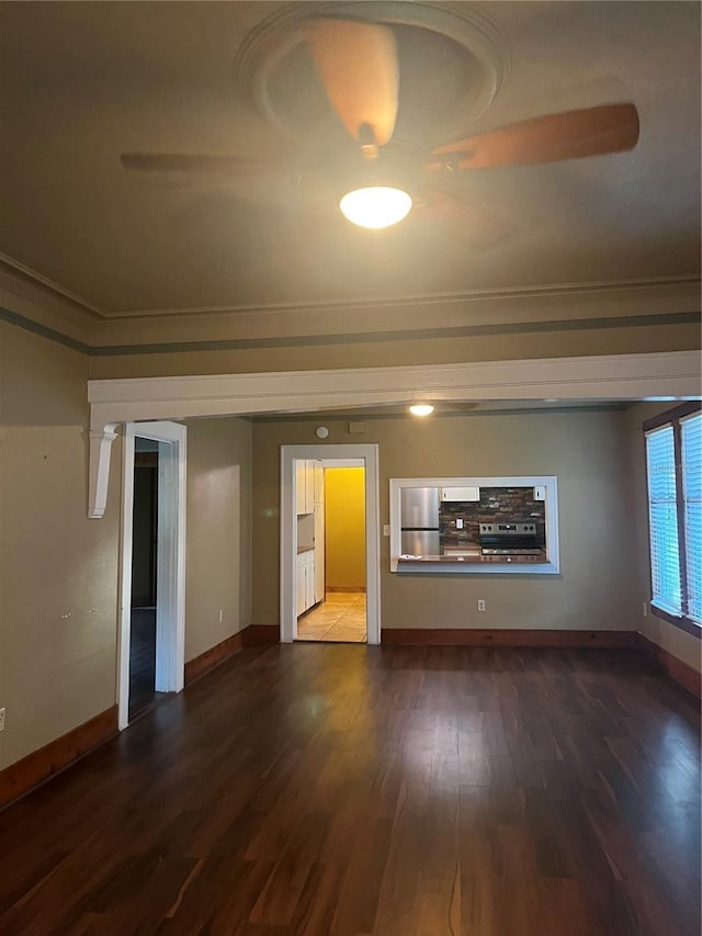 9907 Maggie St, Gibsonton, FL 33534 - unfurnished living room featuring crown molding, wood finished floors, and baseboards