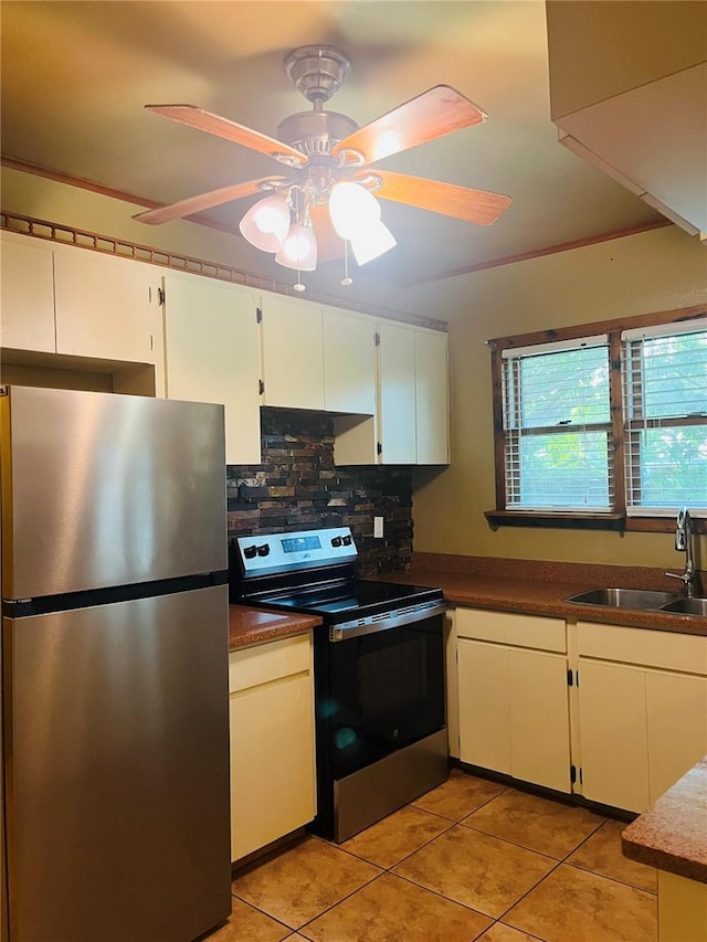 9907 Maggie St, Gibsonton, FL 33534 - kitchen with stainless steel appliances, a sink, backsplash, light tile patterned flooring, and a ceiling fan