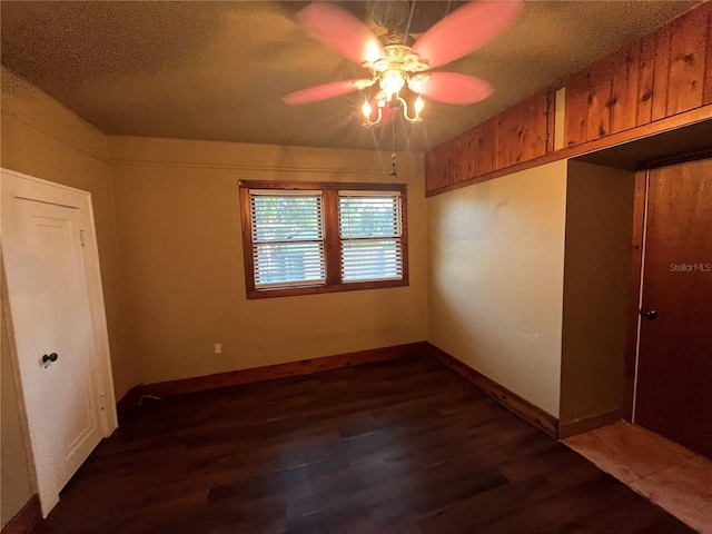 9907 Maggie St, Gibsonton, FL 33534 - spare room featuring ceiling fan, dark wood-style floors, baseboards, and a textured ceiling