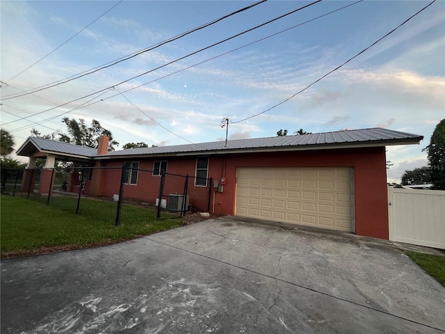 9907 Maggie St, Gibsonton, FL 33534 - ranch-style home featuring concrete driveway, stucco siding, a garage, and metal roof
