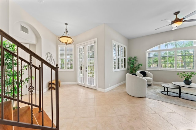 4306 Barracuda Dr, Bradenton, FL 34208 - foyer featuring light tile patterned floors, stairway, and baseboards