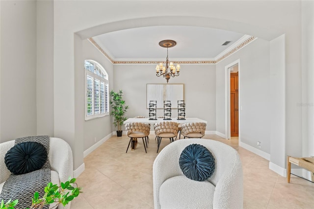 4306 Barracuda Dr, Bradenton, FL 34208 - dining space with crown molding, light tile patterned floors, a chandelier, arched walkways, and baseboards