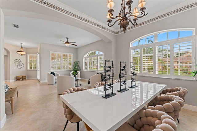 4306 Barracuda Dr, Bradenton, FL 34208 - dining area featuring arched walkways, healthy amount of natural light, baseboards, a ceiling fan, and ornamental molding