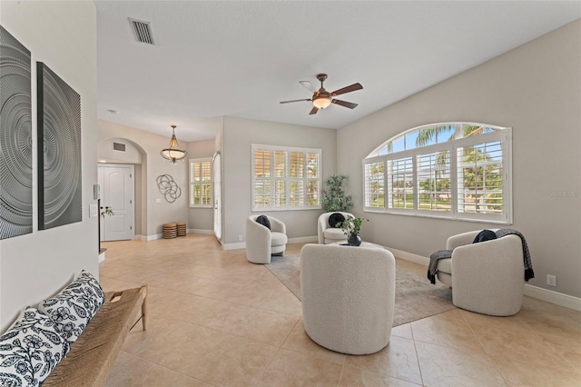 4306 Barracuda Dr, Bradenton, FL 34208 - living area featuring ceiling fan, light tile patterned floors, baseboards, and arched walkways