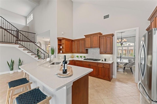 4306 Barracuda Dr, Bradenton, FL 34208 - kitchen featuring stainless steel appliances, open shelves, a peninsula, a towering ceiling, and light countertops