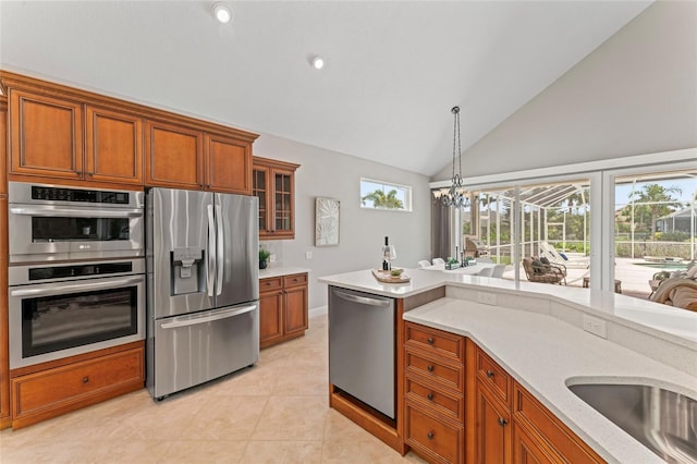4306 Barracuda Dr, Bradenton, FL 34208 - kitchen with stainless steel appliances, brown cabinets, healthy amount of natural light, glass insert cabinets, and high vaulted ceiling
