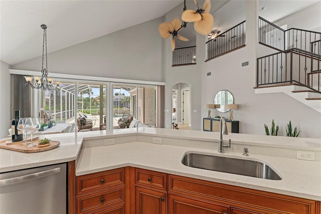 4306 Barracuda Dr, Bradenton, FL 34208 - kitchen featuring stainless steel dishwasher, a sink, brown cabinetry, open floor plan, and high vaulted ceiling