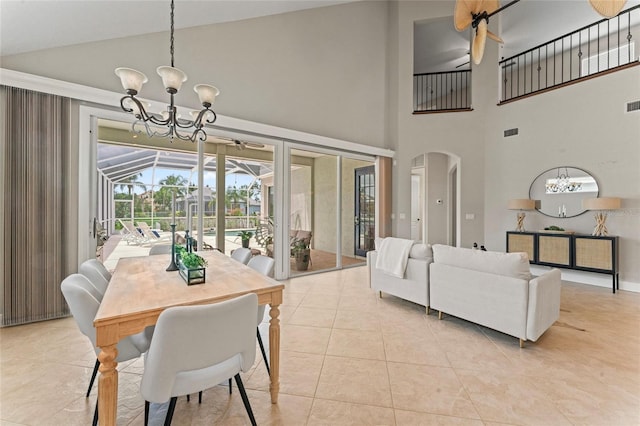 4306 Barracuda Dr, Bradenton, FL 34208 - dining room featuring a chandelier, arched walkways, light tile patterned floors, and high vaulted ceiling