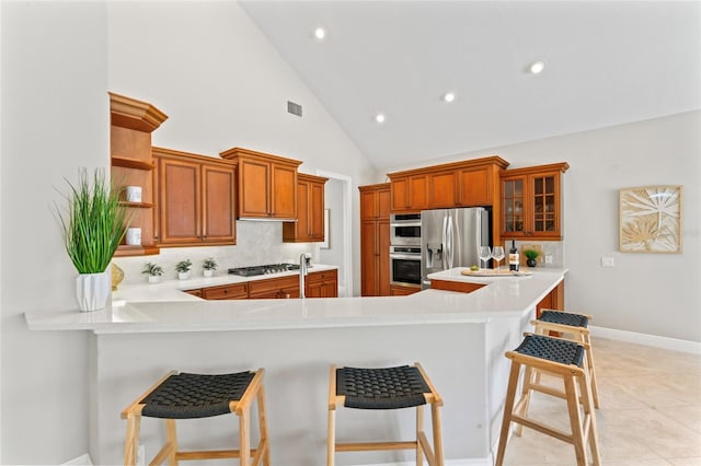 4306 Barracuda Dr, Bradenton, FL 34208 - kitchen with open shelves, light countertops, appliances with stainless steel finishes, backsplash, and a peninsula