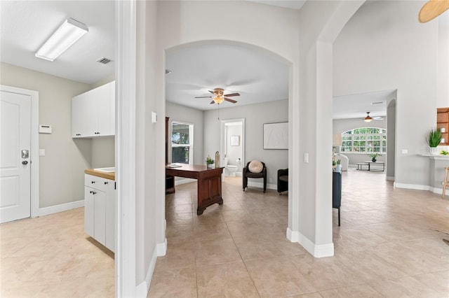 4306 Barracuda Dr, Bradenton, FL 34208 - corridor with arched walkways, light tile patterned floors, and baseboards