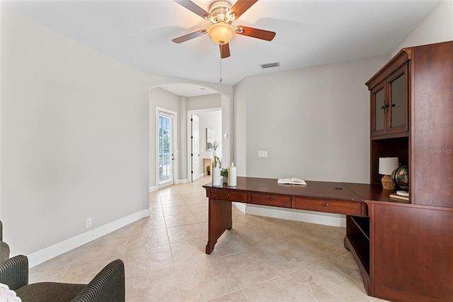 4306 Barracuda Dr, Bradenton, FL 34208 - home office featuring arched walkways, ceiling fan, light tile patterned floors, and baseboards