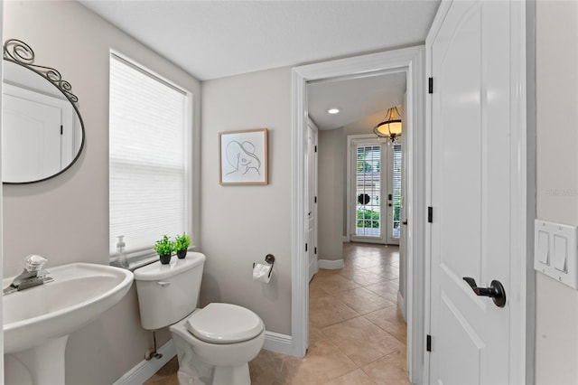 4306 Barracuda Dr, Bradenton, FL 34208 - half bathroom featuring baseboards, toilet, a sink, and tile patterned flooring