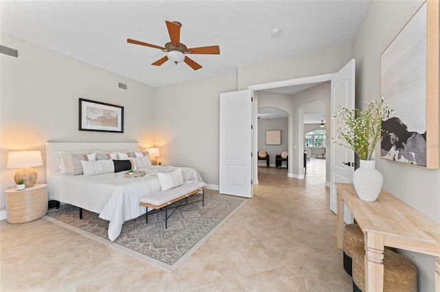 4306 Barracuda Dr, Bradenton, FL 34208 - bedroom with arched walkways, light tile patterned floors, and a ceiling fan