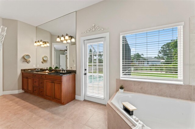 4306 Barracuda Dr, Bradenton, FL 34208 - bathroom featuring a bath, double vanity, tile patterned floors, and baseboards