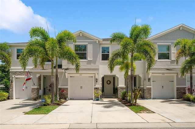 4504 Silver Lining St, Sarasota, FL 34238 - view of front of property featuring a garage, stucco siding, driveway, and stone siding