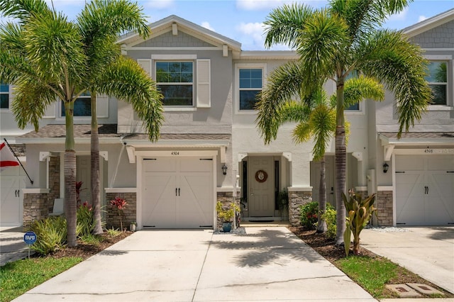 4504 Silver Lining St, Sarasota, FL 34238 - view of front of home with stone siding, concrete driveway, a garage, and stucco siding