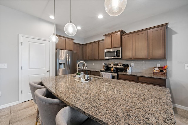4504 Silver Lining St, Sarasota, FL 34238 - kitchen featuring stainless steel appliances, baseboards, a kitchen breakfast bar, tasteful backsplash, and stone countertops