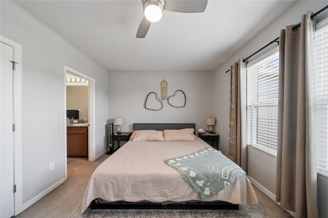 4504 Silver Lining St, Sarasota, FL 34238 - bedroom featuring light colored carpet, baseboards, ensuite bathroom, and a ceiling fan