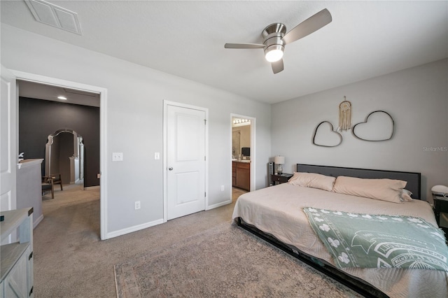 4504 Silver Lining St, Sarasota, FL 34238 - carpeted bedroom with baseboards, arched walkways, ensuite bath, and a ceiling fan
