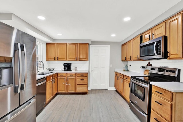 801 Kirkcaldy Way, Valrico, FL 33594 - kitchen with appliances with stainless steel finishes, a sink, light wood finished floors, tasteful backsplash, and light countertops