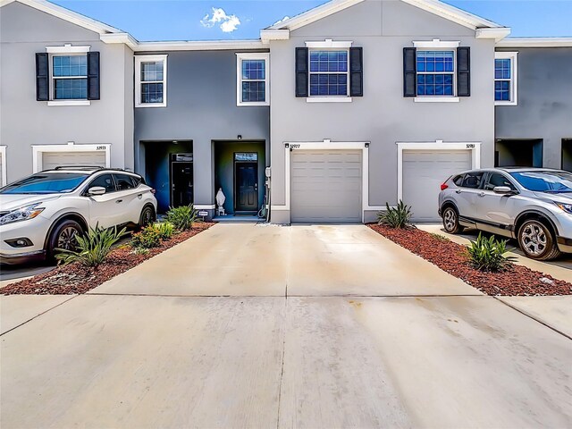 32977 Kaloko Rd, Wesley Chapel, FL 33543 - view of property with an attached garage, driveway, and stucco siding