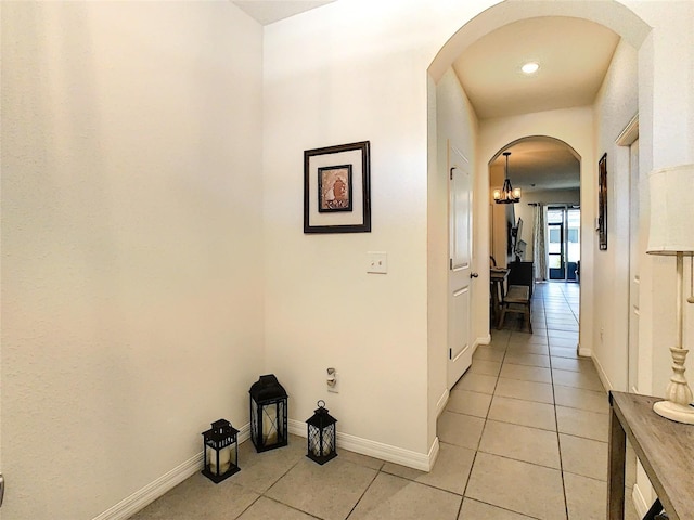 32977 Kaloko Rd, Wesley Chapel, FL 33543 - hallway featuring light tile patterned floors, arched walkways, and recessed lighting