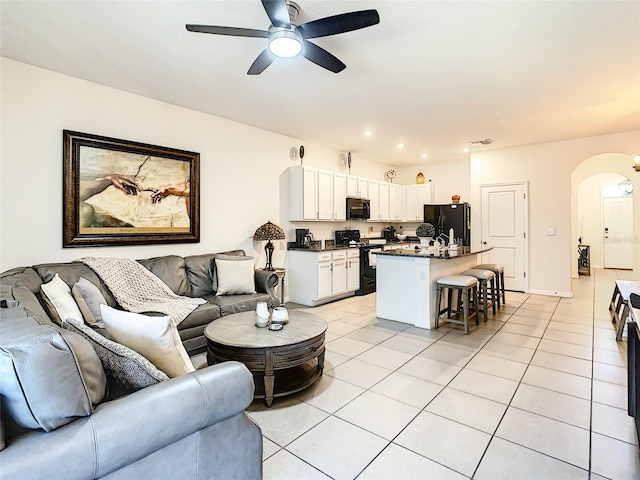 32977 Kaloko Rd, Wesley Chapel, FL 33543 - living area featuring arched walkways, ceiling fan, light tile patterned floors, and recessed lighting