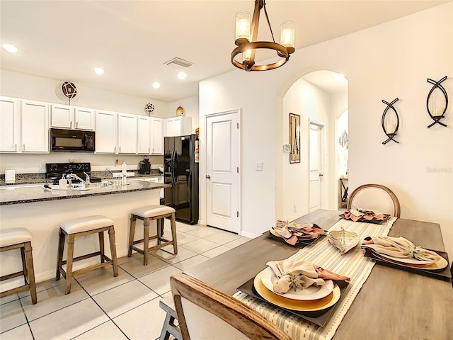 32977 Kaloko Rd, Wesley Chapel, FL 33543 - dining area featuring arched walkways, a chandelier, light tile patterned floors, and recessed lighting
