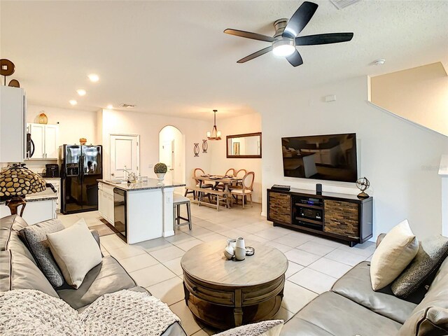 32977 Kaloko Rd, Wesley Chapel, FL 33543 - living room featuring arched walkways, light tile patterned floors, ceiling fan, and recessed lighting