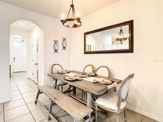 32977 Kaloko Rd, Wesley Chapel, FL 33543 - dining space with a chandelier, arched walkways, and light tile patterned flooring