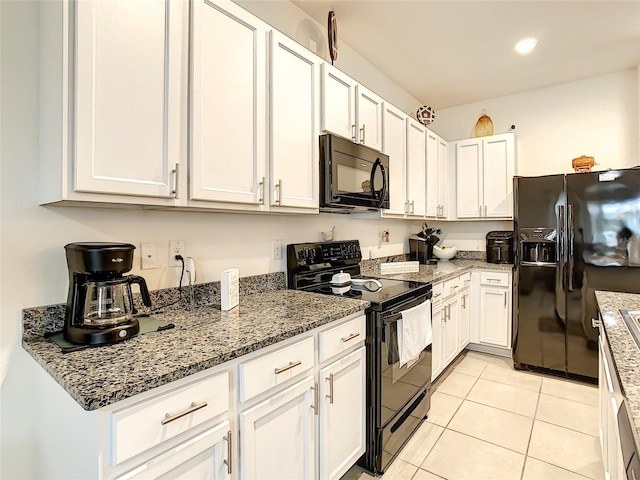 32977 Kaloko Rd, Wesley Chapel, FL 33543 - kitchen with black appliances, white cabinetry, stone countertops, and recessed lighting