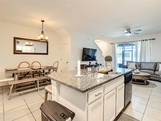 32977 Kaloko Rd, Wesley Chapel, FL 33543 - kitchen with open floor plan, light tile patterned flooring, dishwasher, stone counters, and white cabinets