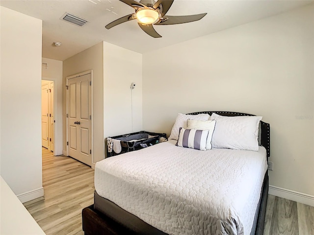 32977 Kaloko Rd, Wesley Chapel, FL 33543 - bedroom with light wood finished floors and ceiling fan