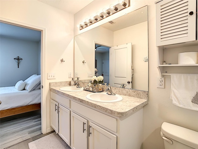 32977 Kaloko Rd, Wesley Chapel, FL 33543 - bathroom with ensuite bath, double vanity, and wood finished floors