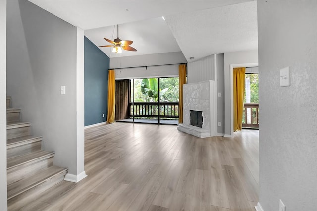 1038 E Michigan St Unit B, Orlando, FL 32806 - unfurnished living room with vaulted ceiling, baseboards, stairway, light wood-style flooring, and ceiling fan