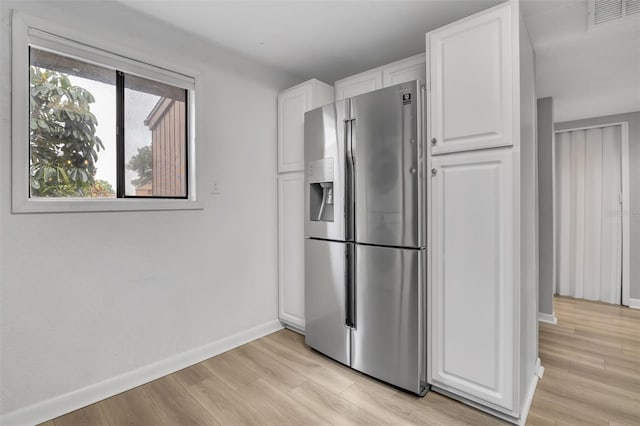 1038 E Michigan St Unit B, Orlando, FL 32806 - kitchen featuring stainless steel fridge with ice dispenser, baseboards, white cabinets, and light wood-style floors