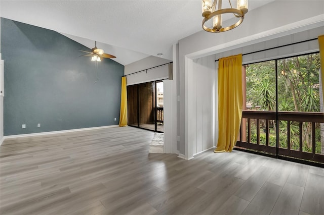 1038 E Michigan St Unit B, Orlando, FL 32806 - unfurnished room featuring a chandelier, vaulted ceiling, wood finished floors, ceiling fan, and baseboards