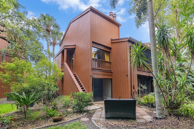 1038 E Michigan St Unit B, Orlando, FL 32806 - view of front of house with a chimney, stairway, a patio, and a balcony