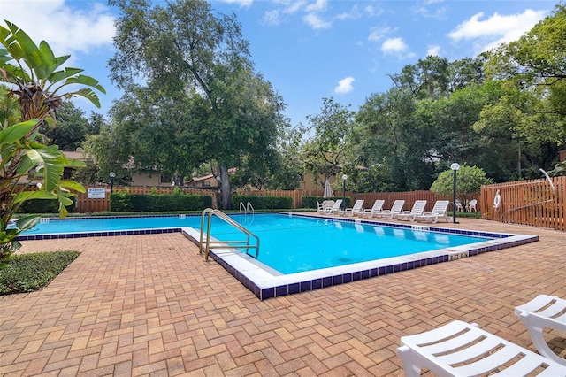 1038 E Michigan St Unit B, Orlando, FL 32806 - community pool with a patio area and view of wooded area