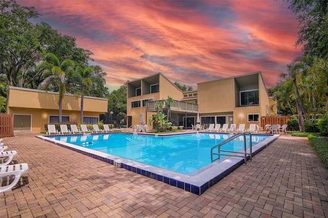 1038 E Michigan St Unit B, Orlando, FL 32806 - pool at dusk with a community pool and a patio area