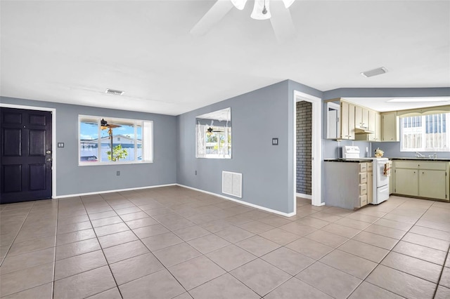 1415 Yale Dr, Holiday, FL 34691 - kitchen with range, ceiling fan, light tile patterned floors, and healthy amount of natural light