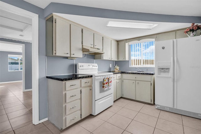 1415 Yale Dr, Holiday, FL 34691 - kitchen with white appliances, under cabinet range hood, and light tile patterned flooring