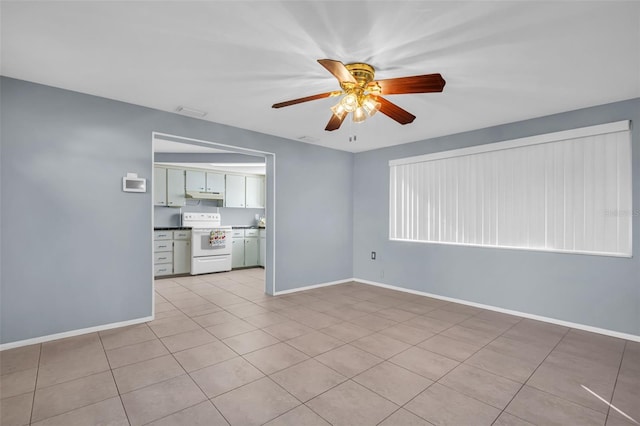 1415 Yale Dr, Holiday, FL 34691 - unfurnished living room featuring ceiling fan and light tile patterned flooring