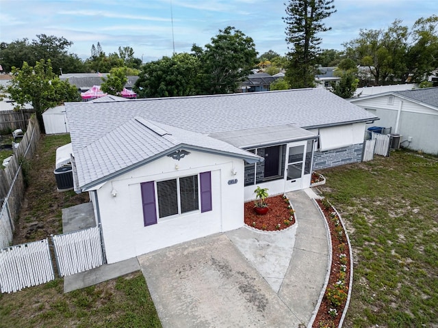 1415 Yale Dr, Holiday, FL 34691 - back of house with a fenced backyard, roof with shingles, a patio, and a sunroom
