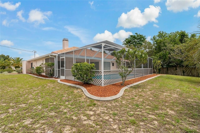 11411 Terrell, Spring Hill, FL 34606 - rear view of house with a chimney and glass enclosure