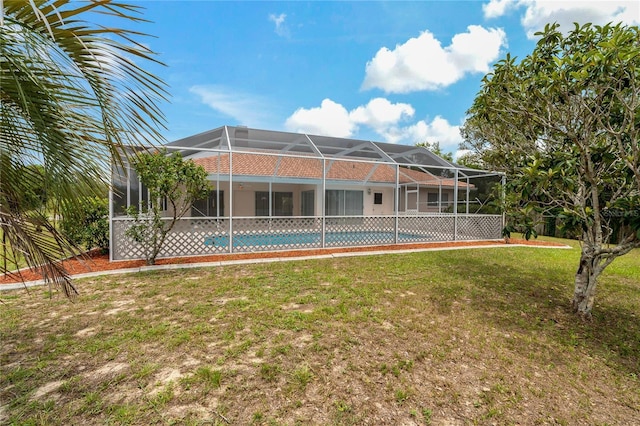 11411 Terrell, Spring Hill, FL 34606 - rear view of property featuring a yard, an outdoor pool, and glass enclosure